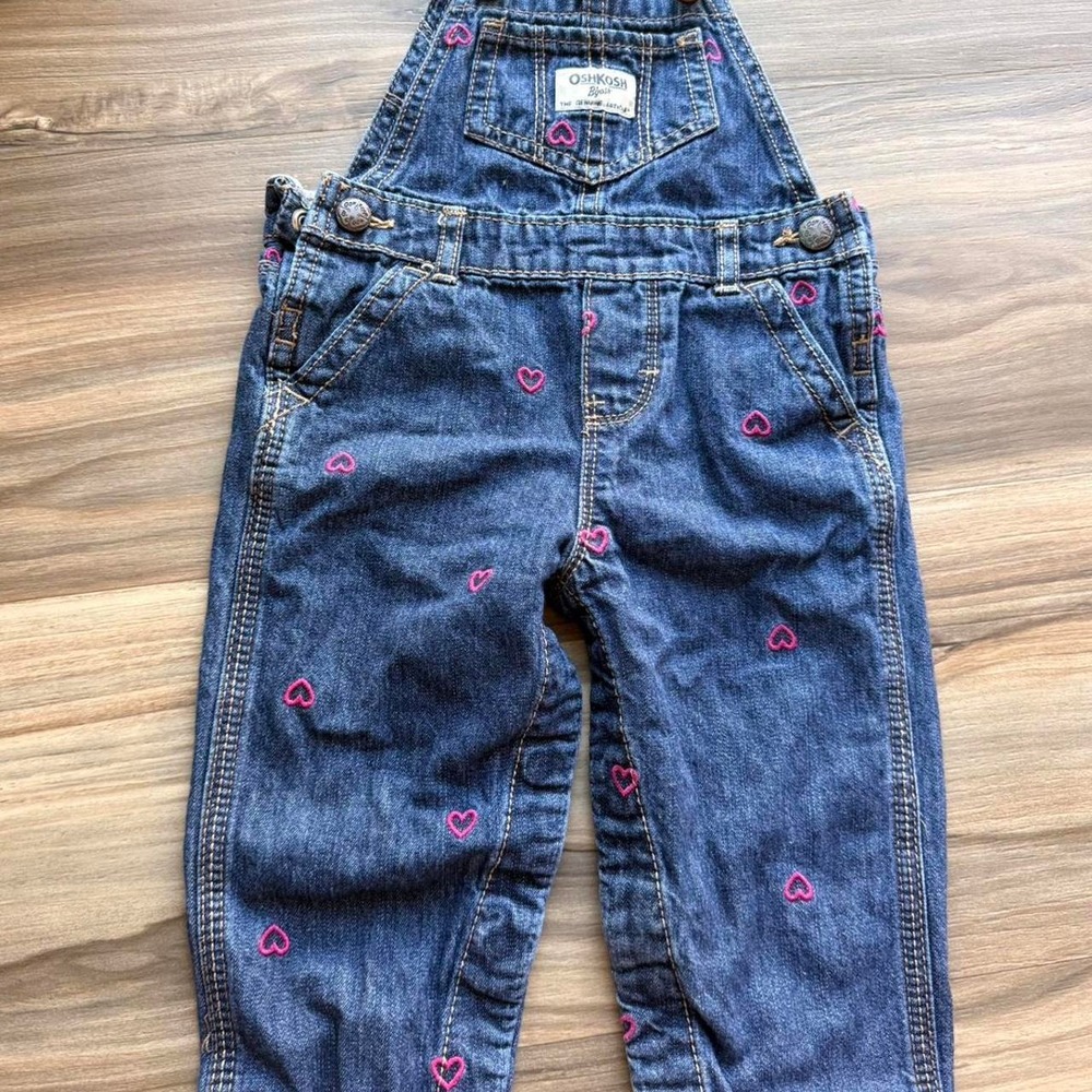 OshKosh B'gosh blue denim overalls with pink heart embroidery